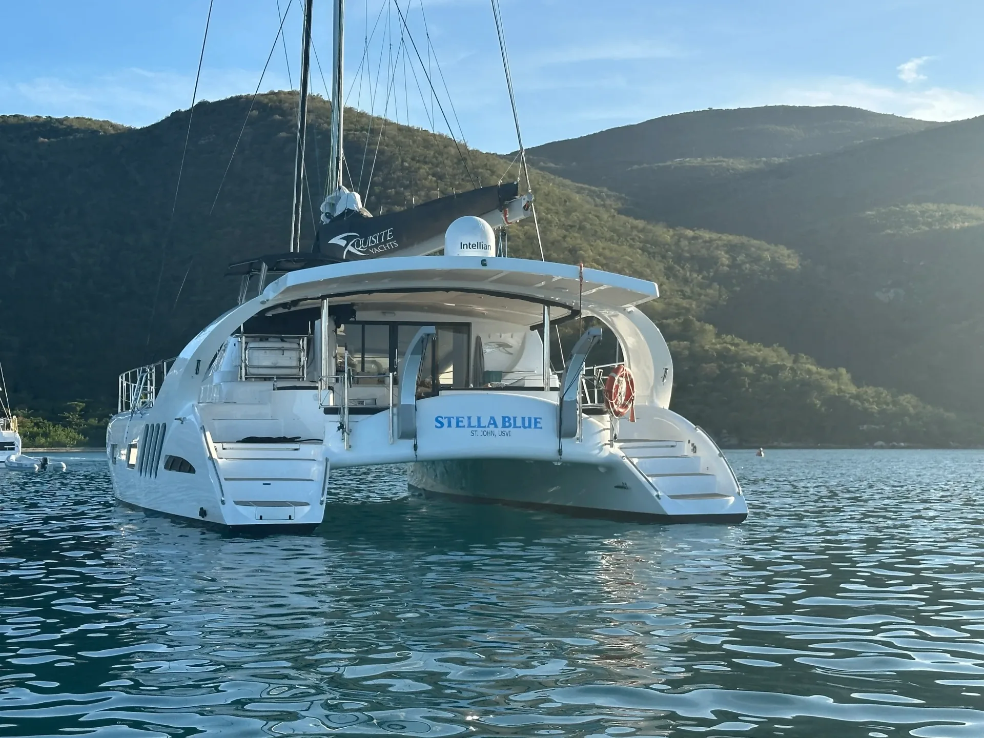 Cockpit dining area and aft chaise lounge aboard Stella Blue luxury catamaran