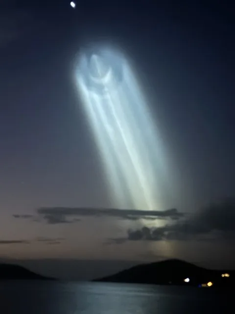 SpaceX rocket launch contrail glowing over the Virgin Islands at twilight, seen from the deck of Stella Blue