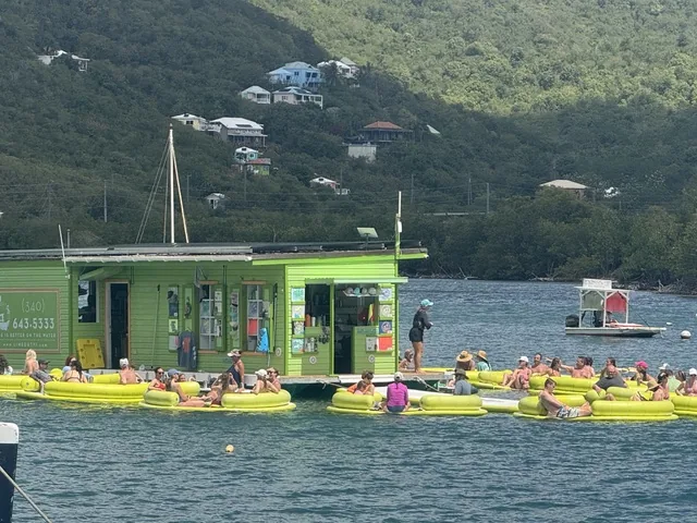 Guests floating on lime-green tubes at the Lime Out floating taco bar in Coral Bay, St. John USVI