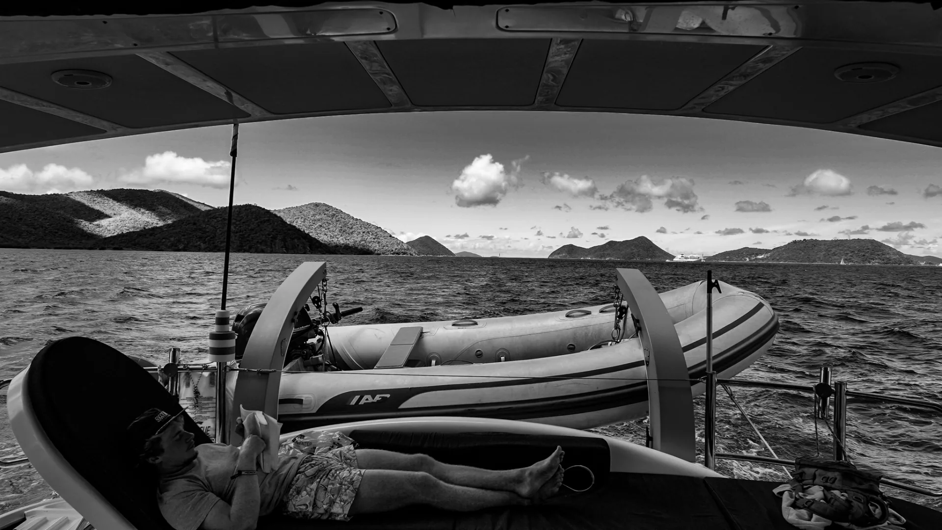 View from under the bimini across the aft deck to the Virgin Islands — black and white